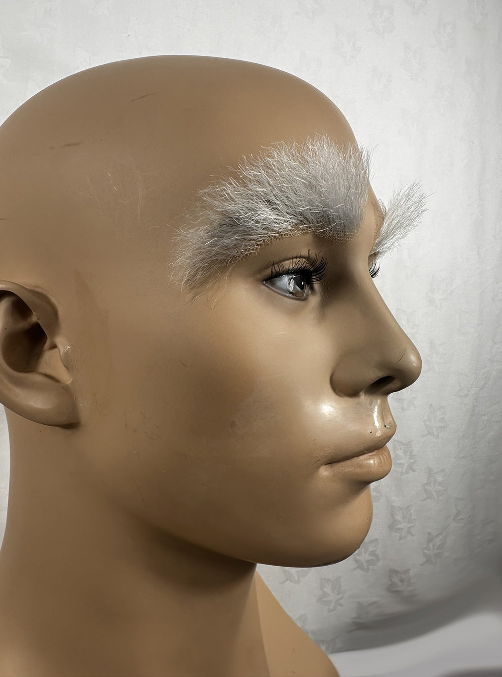 Image of large white prosthetic eyebrow no7