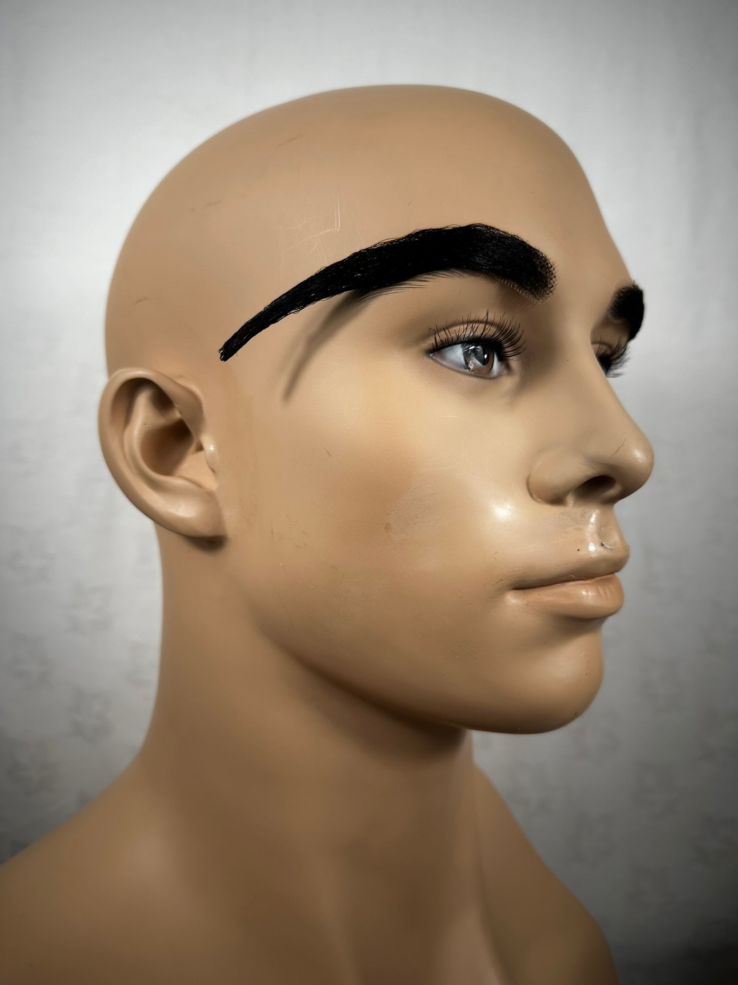 Picture of a large set of prosthetic eyebrows