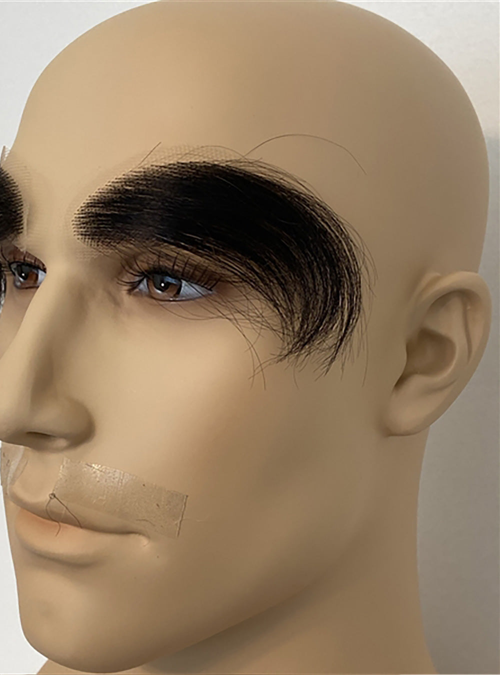 Close up of Extra Long Prosthetic Eyebrows